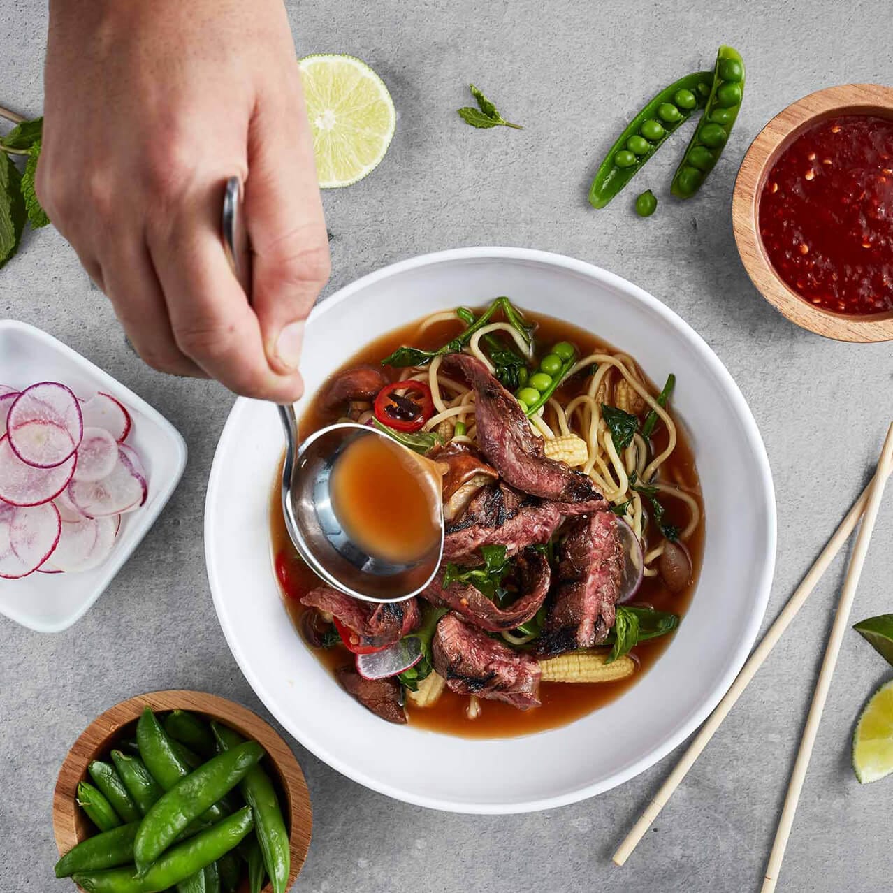 An overhead shot of a bowl of ramen filled with noodles, meat and fresh vegetables at the Urban Pantry at Universal Orlando's Aventura Hotel.