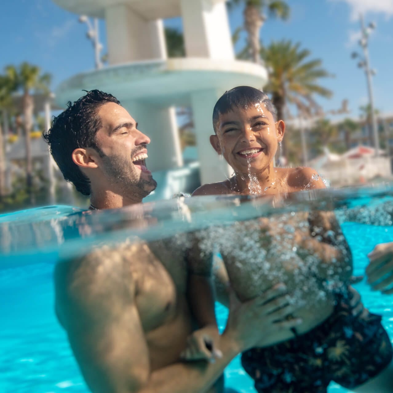 A family laughing and playing in the pool at Universal Cabana Bay Beach Resort.