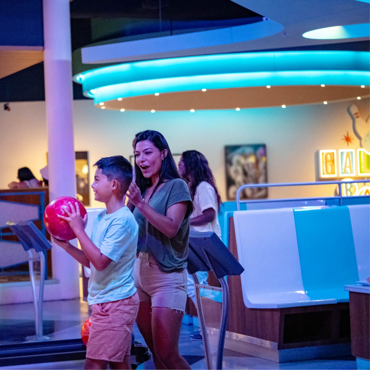 A family bowls at Galaxy Bowl located in Universal Cabana Bay Beach Resort