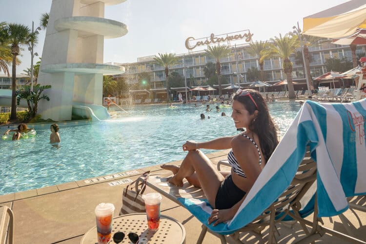 A girl lounging by the pool at Universal's Cabana Bay Beach Resort.