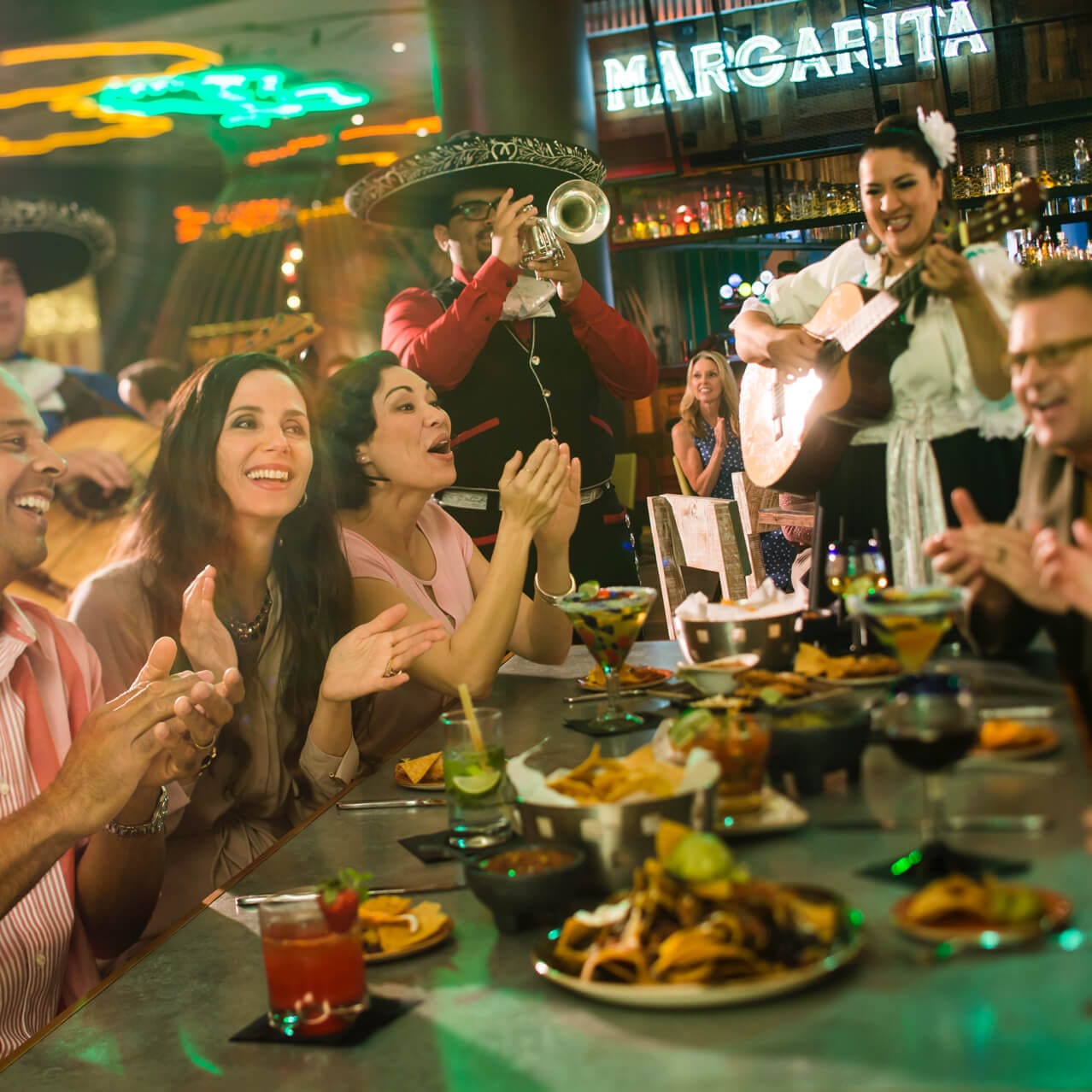 Customers laugh and clap along to the live Mariachi band at Antojitos Authentic Mexican Food in Universal CityWalk