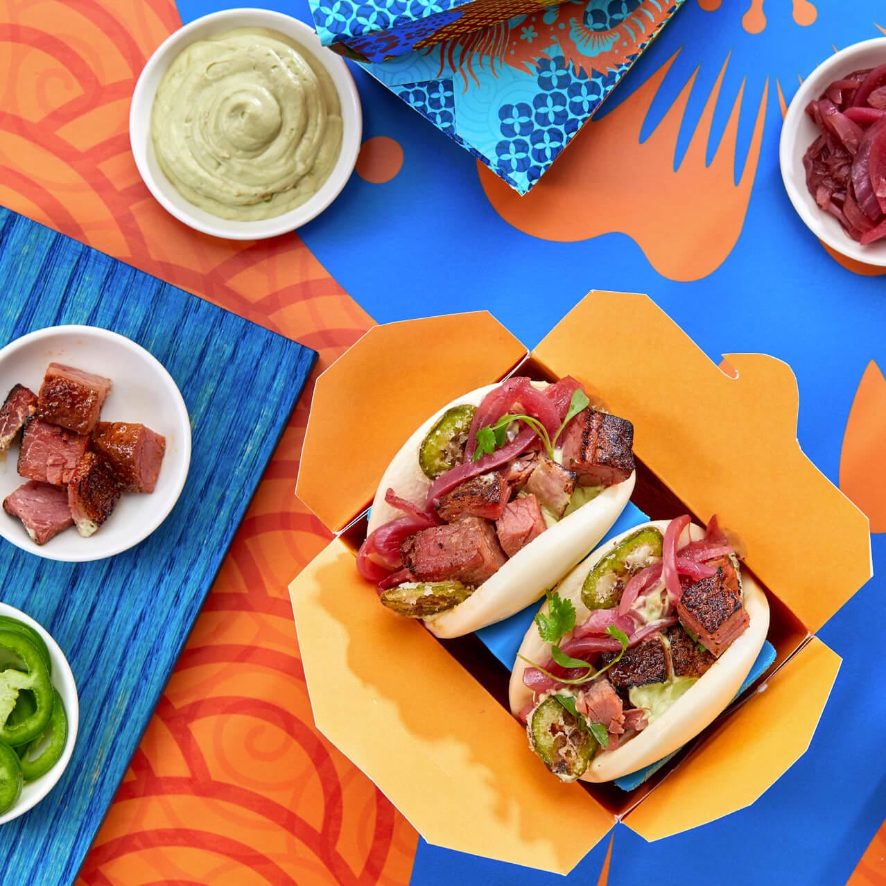 Beef Brisket baos with side sauces and food samples at Bend the Bao restaurant in Universal CityWalk.