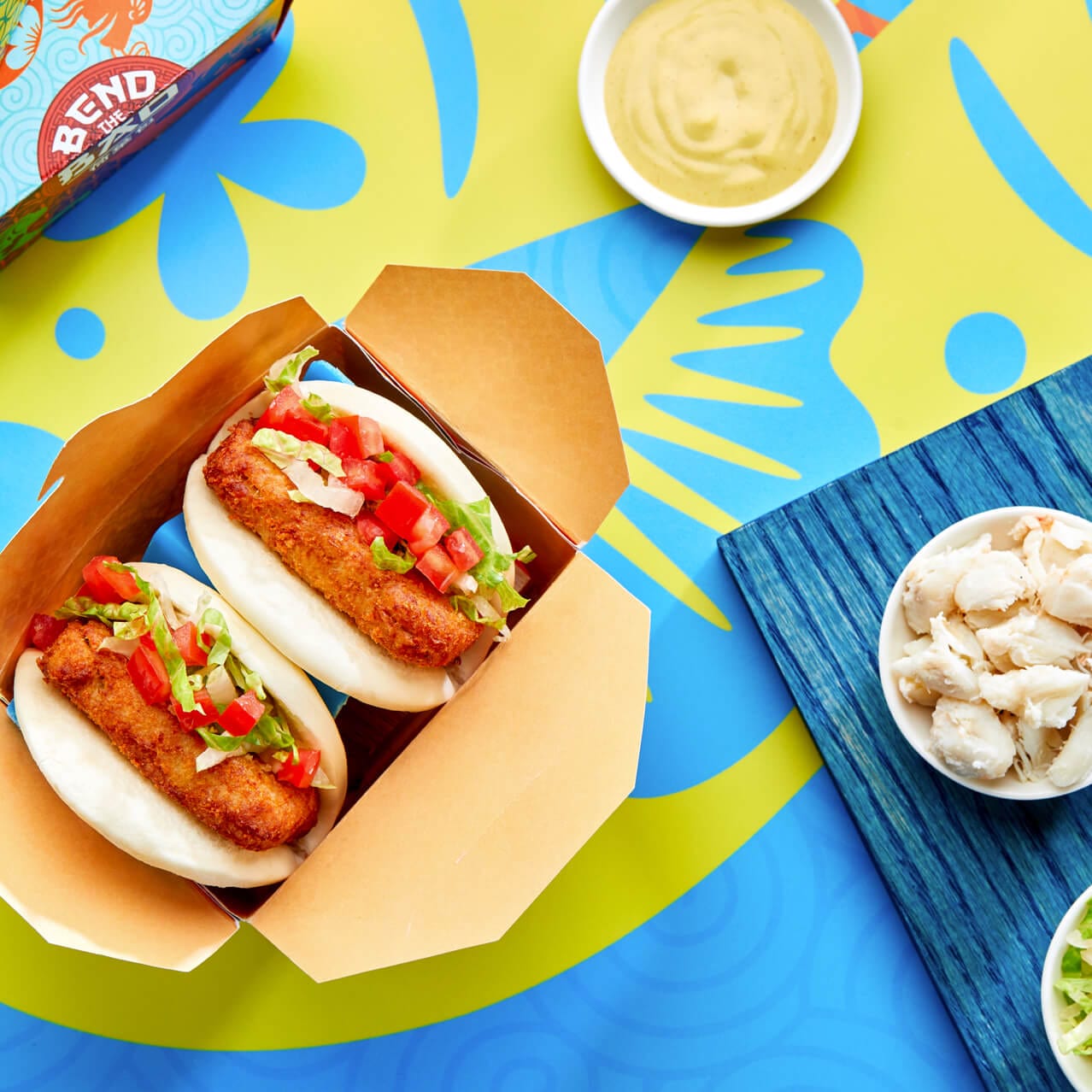 Crab Cake baos with side sauce and food samples at Bend the Bao restaurant in Universal CityWalk.