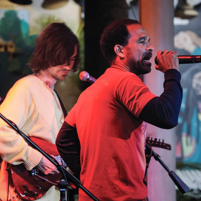 A singer and guitar player on stage inside Bob Marley A Tribute to Freedom at Universal CityWalk.