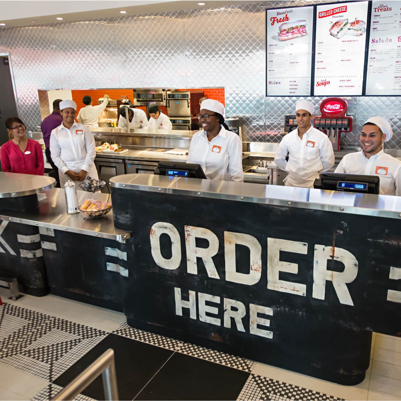 Smiling cashiers behind the counter at Universal CityWalk's Bread Box Handcrafted Sandwiches shop