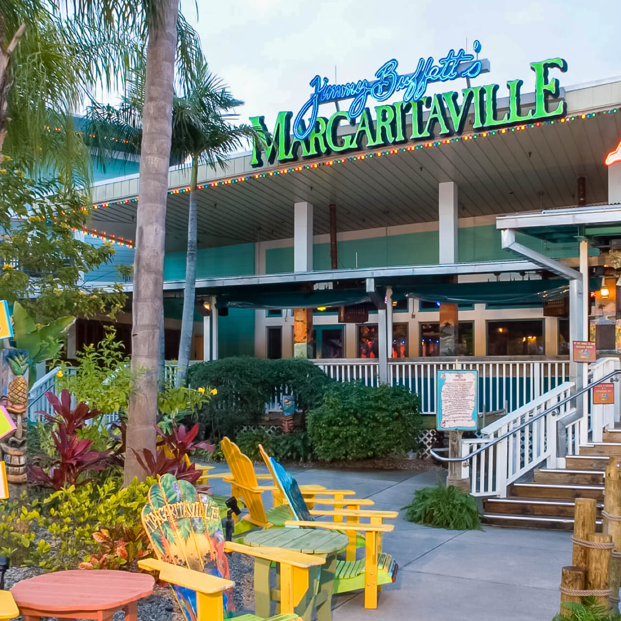 Palm trees and Adirondack chairs create a tropical feel outside of Jimmy Buffett's Margaritaville at Universal CityWalk.