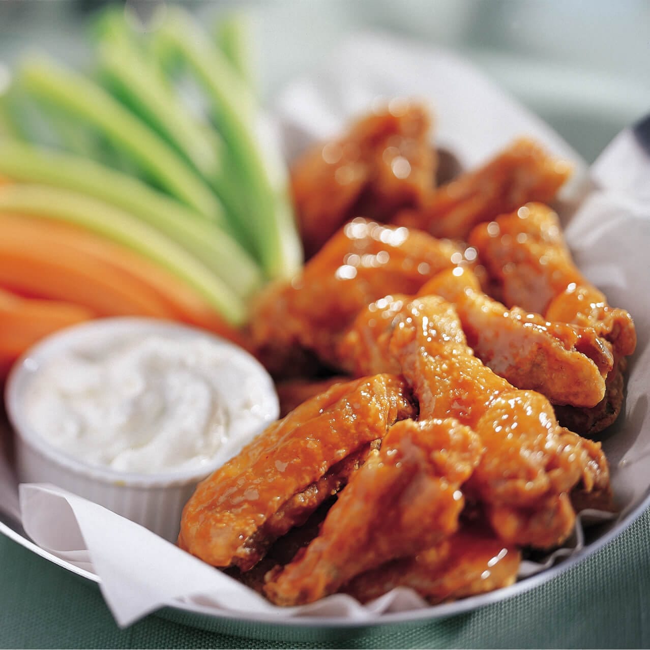 Pat O’Brien’s Crispy wings tossed in a signature sauce with a side of blue cheese, carrots and celery.