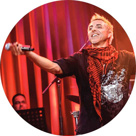 A singer stands on stage inside CityWalk's Rising Star at Universal Orlando in front of a live band.