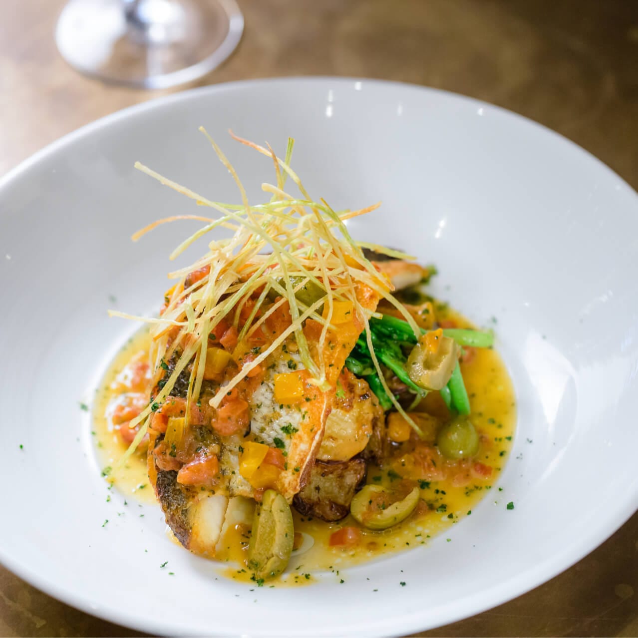 An elegant salmon dish accented with olives and tomatoes from Vivo Italian Kitchen at Universal CityWalk.