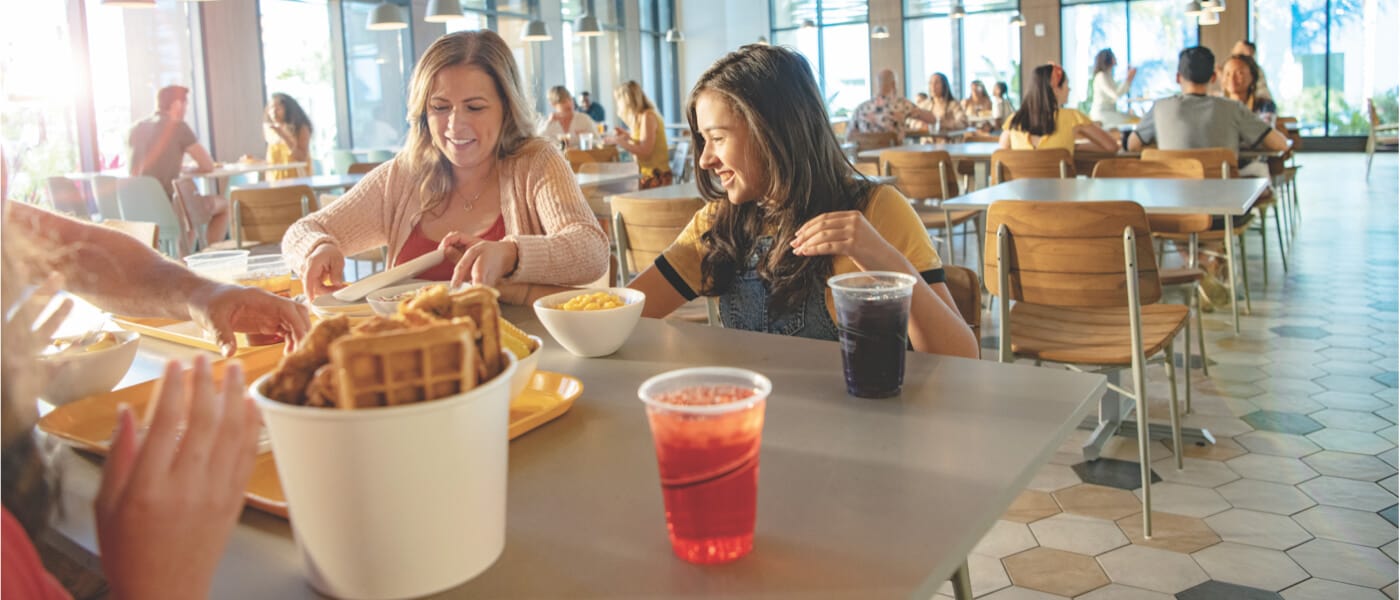 A family enjoys a meal at Pier 8 Market, the casual food court at  Universal Endless Summer Resort - Dockside Inn and Suites.