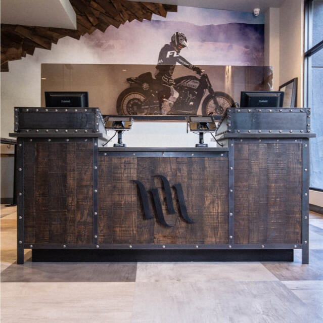 A wooden welcome desk at Hart & Huntington Tattoo Company.