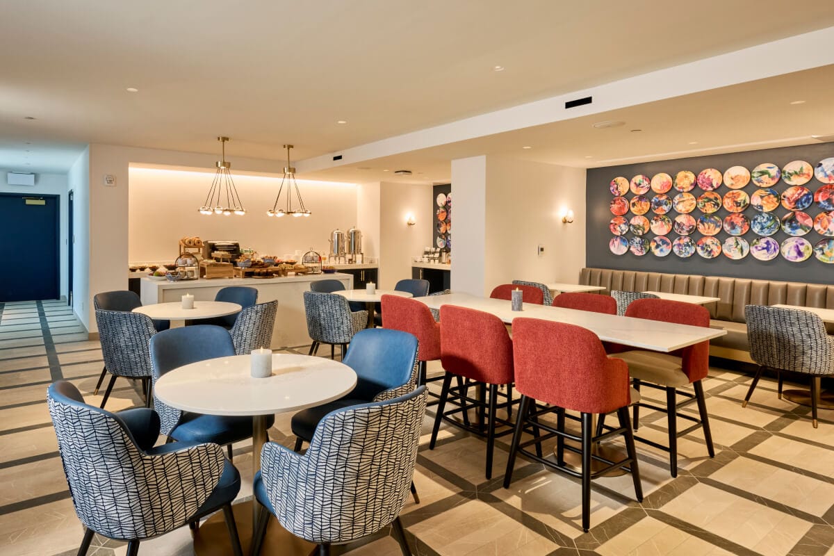 Universal Helios Grand Hotel club lounge area, with seating, and pastries against the far bar area.