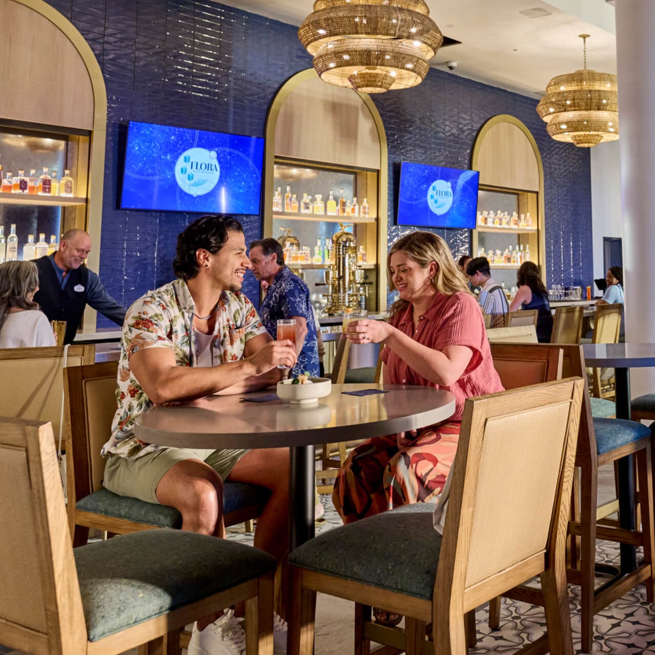 Guests enjoying a meal in Flora Taverna, inside Universal Helios Grand Hotel, a Loews Hotel.