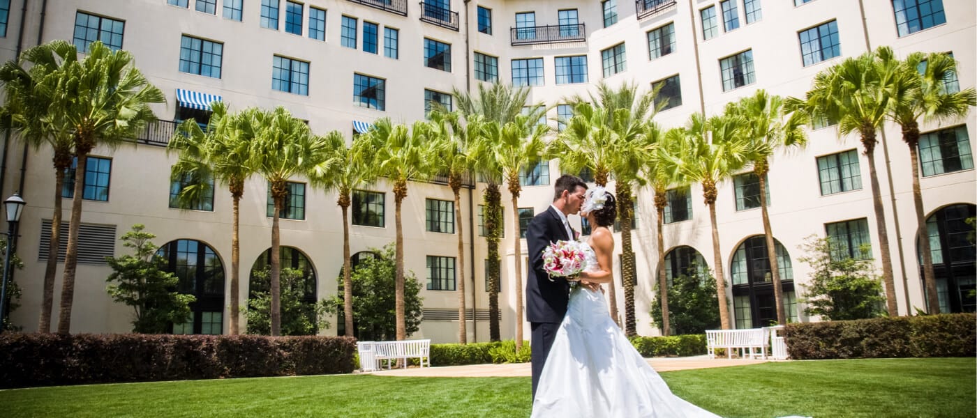A bride and a groom on the lawn of Hard Rock Hotel during their wedding.