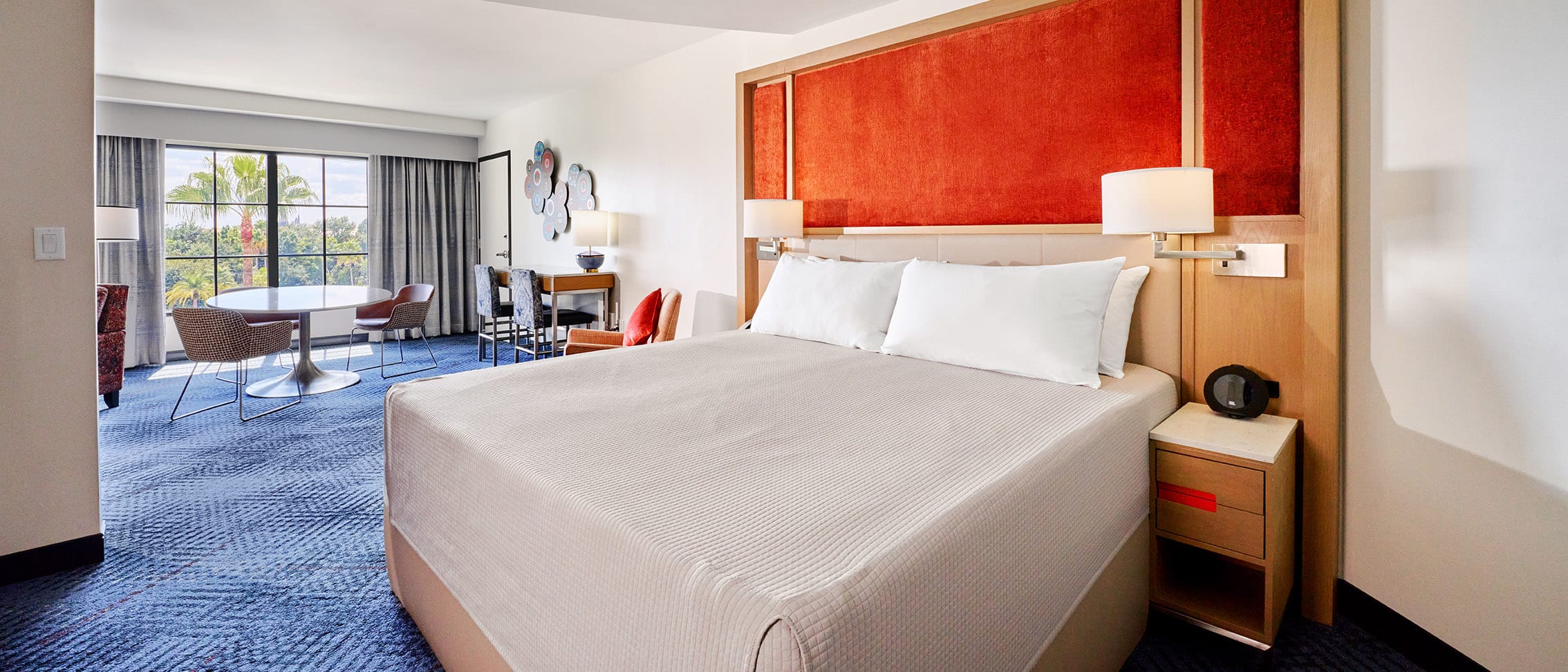 A guitar rests on a bed inside a guest room in Hard Rock Hotel at Universal Orlando, where you can check out a guitar and amp to rock out in your room.