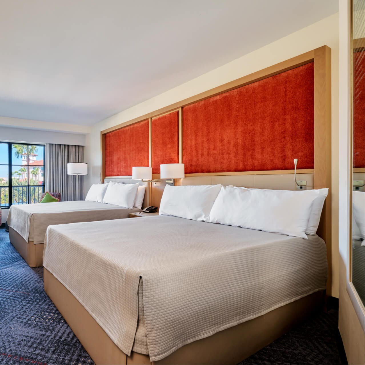 A nighttime interior view of a Guest Room with two Queen beds at Hard Rock hotel in Universal Orlando.