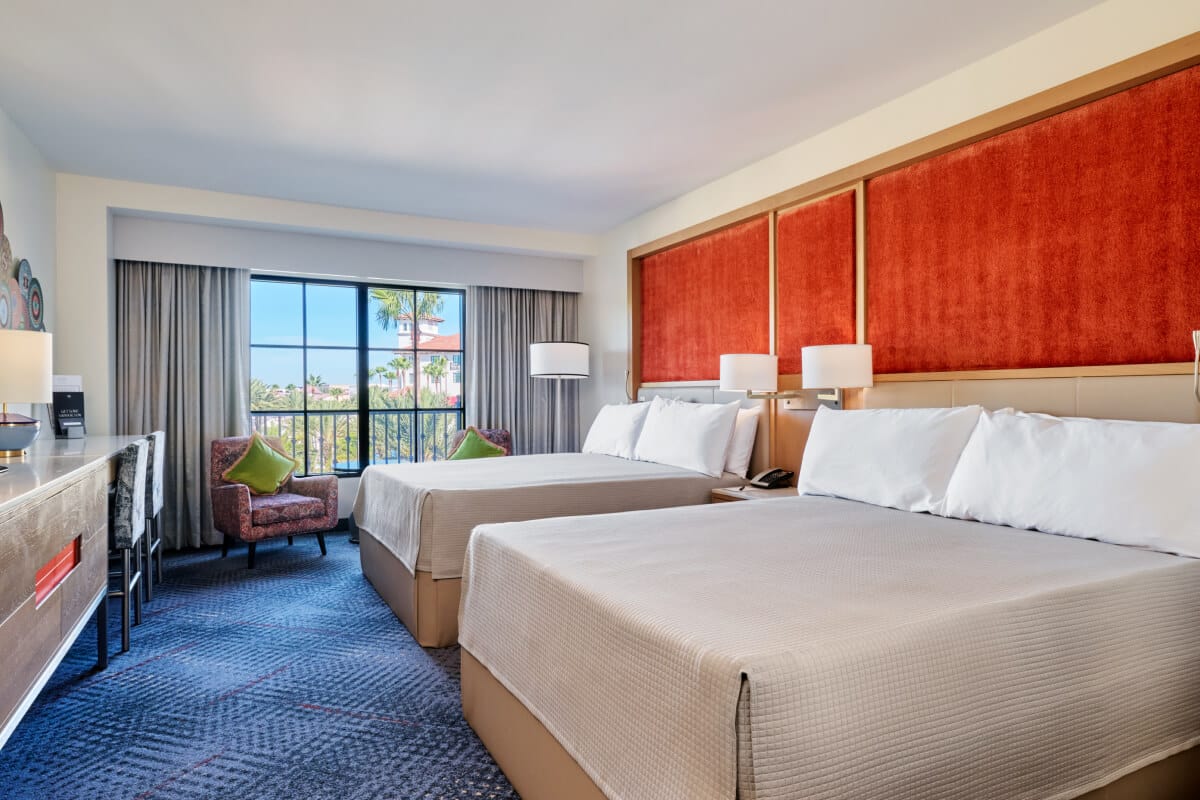 A nighttime interior view of a Guest Room with two Queen beds at Hard Rock hotel in Universal Orlando.