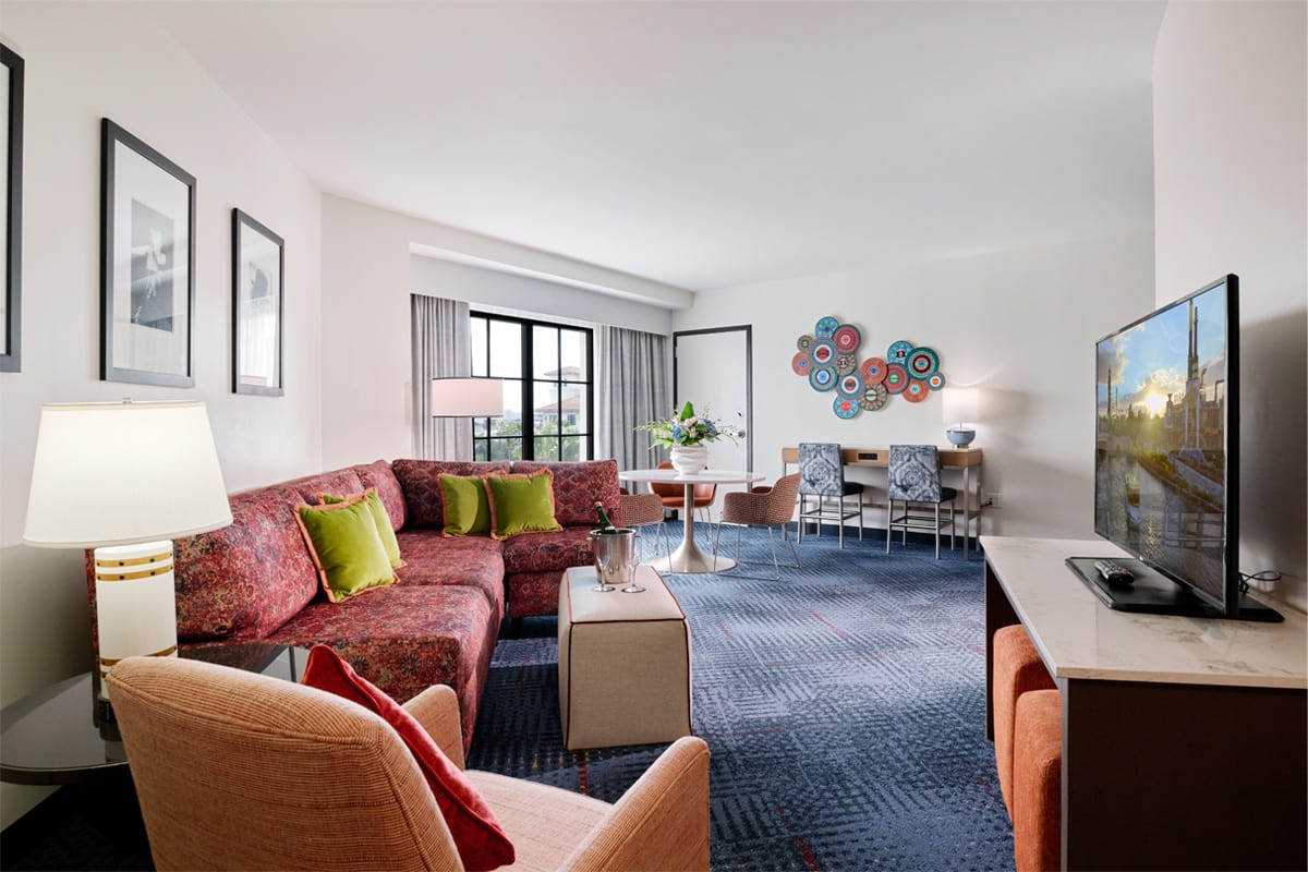 A view of the roomy sofa and lounge area with flat screen TV inside a Hard Rock Hotel King Suite.