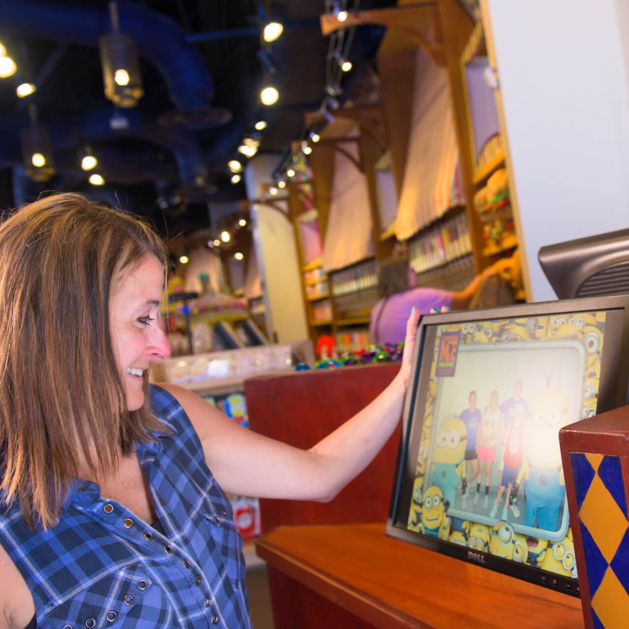 A woman looks at a family photo with a Minions border from Universal Orlando Resort.