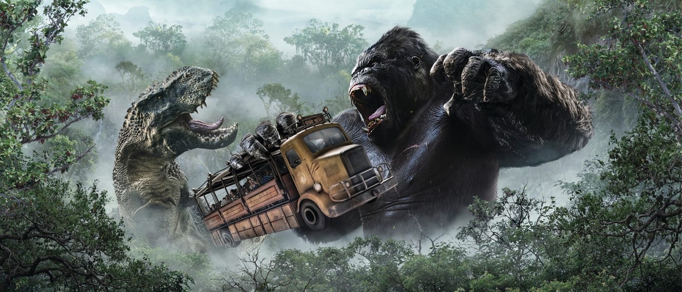 Kong holding a school bus while fighting with a T-Rex