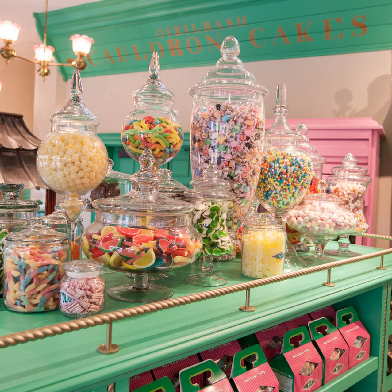 A family exploring all the delicious treats inside Honeydukes sweet shop in The Wizarding World of Harry Potter at Universal's Islands of Adventure.