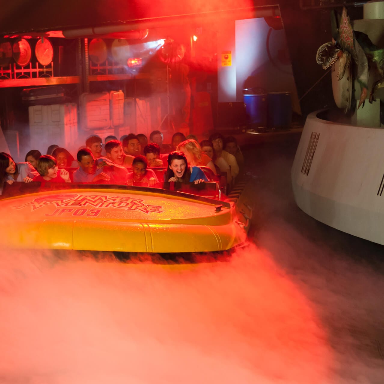 Guests screaming in excitement as they're surprised by dinosaurs during the Jurassic Park River Adventure thrill ride at Universal Studios Orlando.