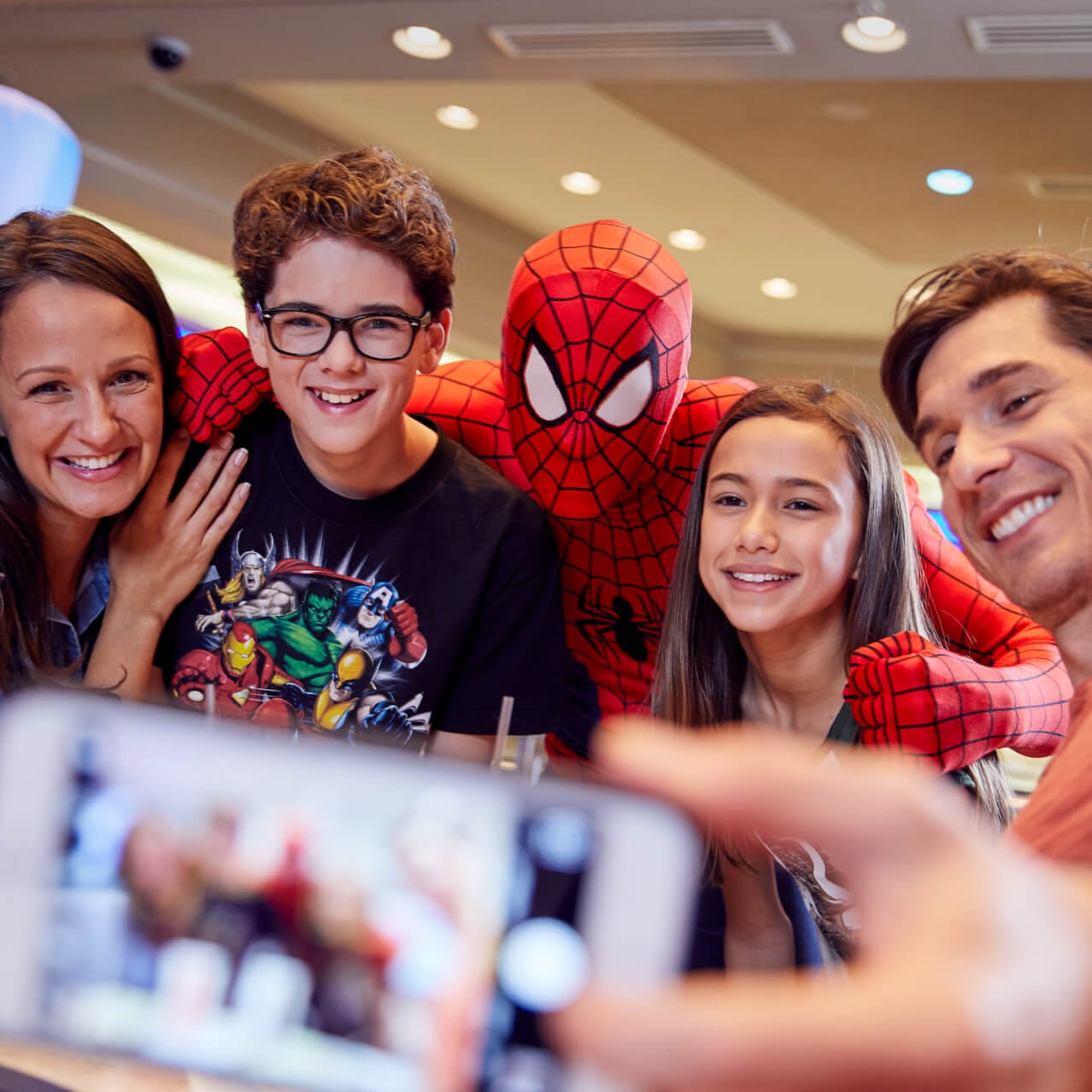 A family poses for a selfie with Spider-Man during Universal Orlando’s Marvel Character Dinner.
