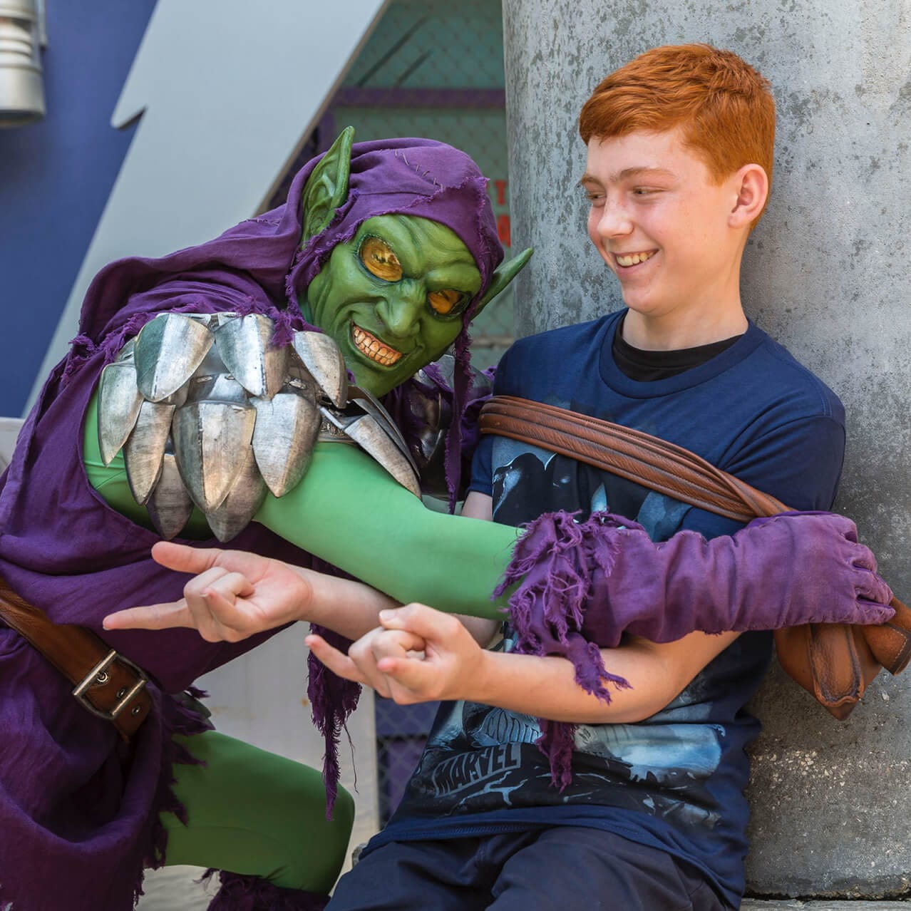 The Green Goblin reenacts a scene from Spider Man with a young guest who pretends to be the web slinger himself at Universal's Islands of Adventure in Orlando.