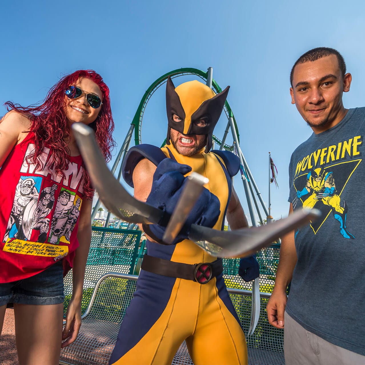 Wolverine extends his impressive claws as he poses with a couple wearing Marvel T shirts at Universal's Islands of Adventure in Orlando.