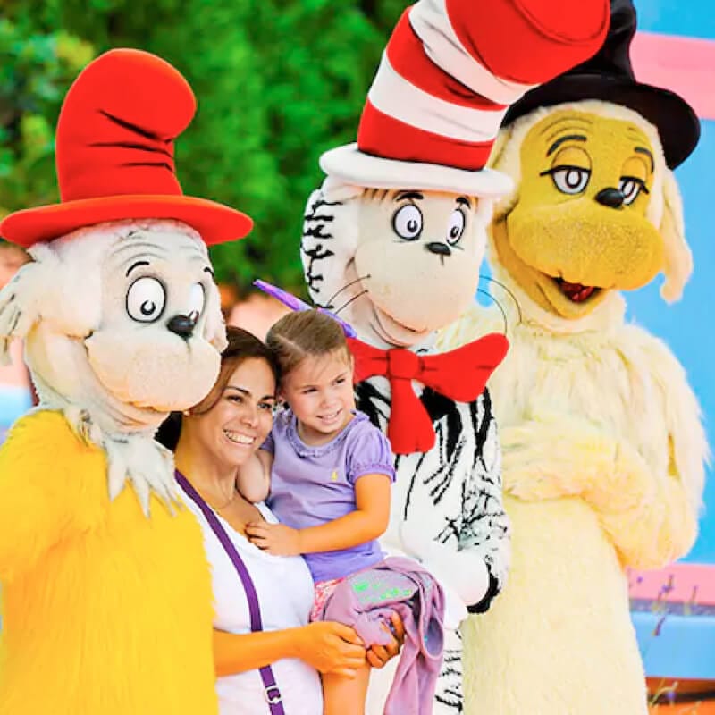 A mom and child pose with Dr. Seuss characters from the Oh! The Stories You’ll Hear! show at Islands of Adventure.