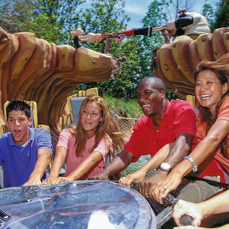 A group holds on tight as their raft spins through the Popeye & Bluto’s Bilge-Rat Barges ride.