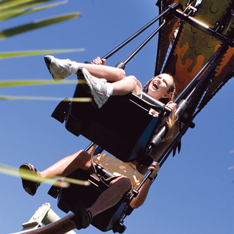 A mother and daughter ride in the double seat glider of the Pteranodon Flyers ride at Islands of Adventure.