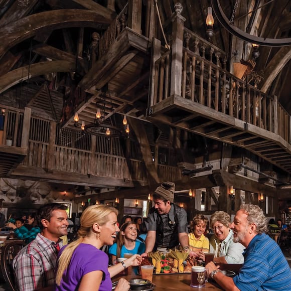 Visitors to The Wizarding World of Harry Potter Hogsmeade at Universal's Islands of Adventure enjoying a delicious meal in the Three Broomsticks restaurant.