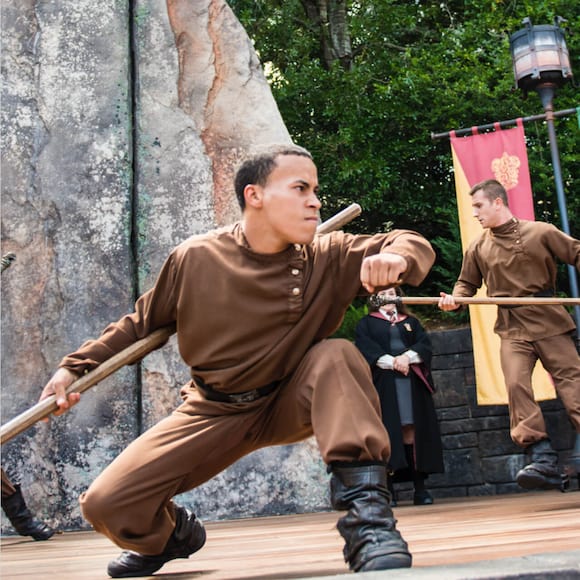 A male Durmstrang student demonstrating his skill in the Triwizard Spirit Rally live show in The Wizarding World of Harry Potter at Universal's Islands of Adventure.