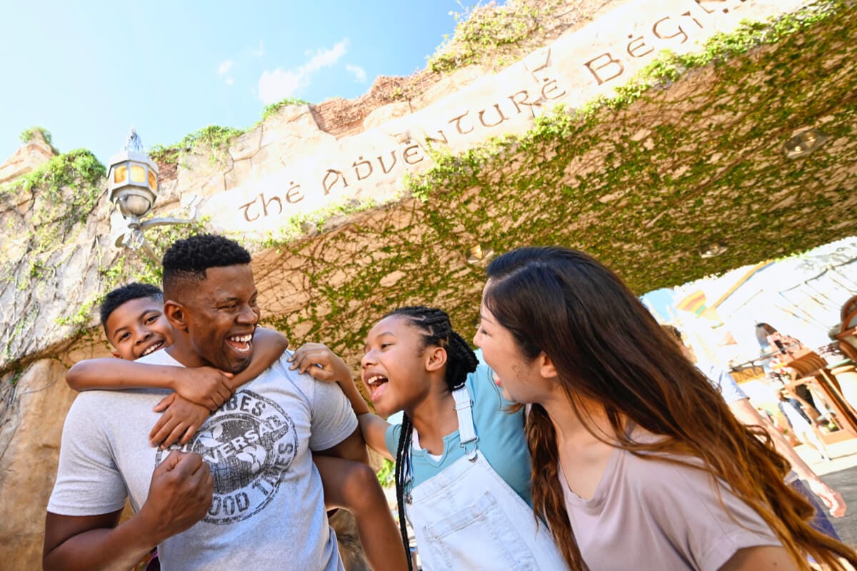 A family of four enjoy their time together while walking through Universal Islands of Adventure.