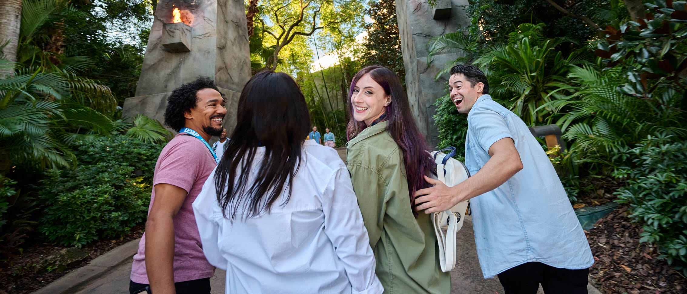 A group of four Passholder friends walking and smiling in Islands of Adventure