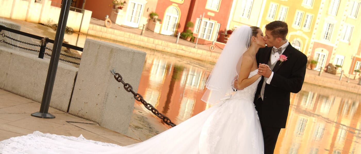 A bride and groom on the piazza at Loews Portofino Bay Hotel.