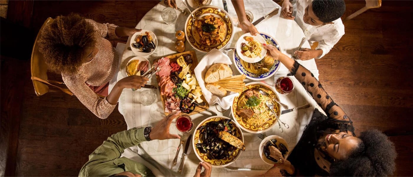 An overhead view of a family enjoying an Italian meal at a Portofino Bay Hotel restaurant at Universal Orlando Resort.