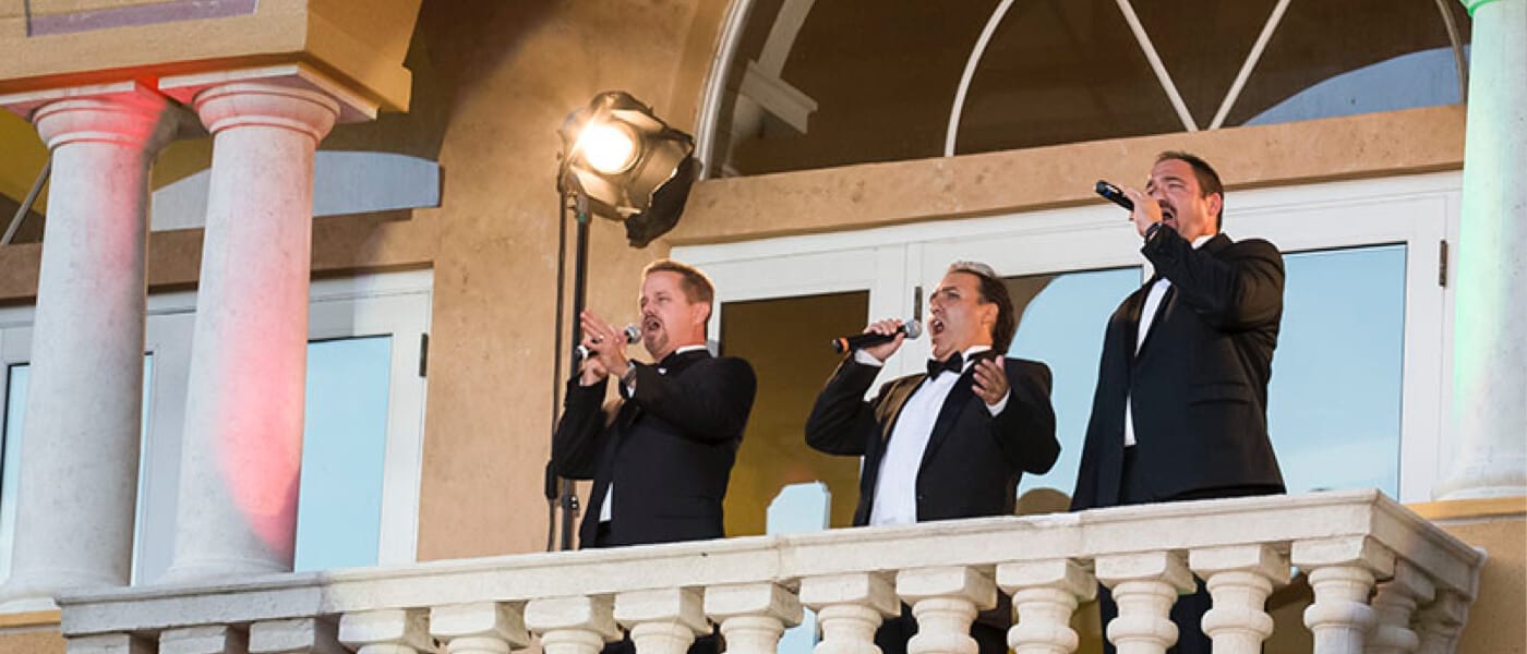 Three men sing classics on a balcony during Musica Della Notte at Loews Portofino Bay Hotel at Universal Orlando