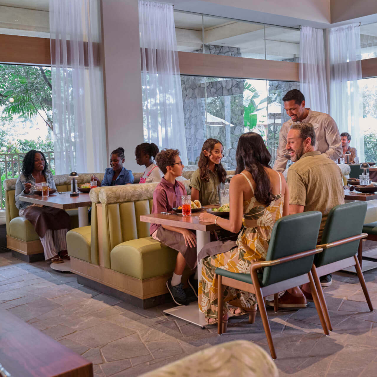 Guests in the dining area of Islands Dining Room in Loews Royal Pacific Resort.