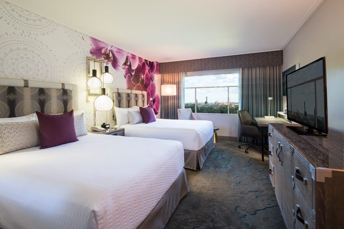Two queen beds inside a Guest Room at Loews Royal Pacific Resort, a preferred on site resort hotel at Universal Orlando.