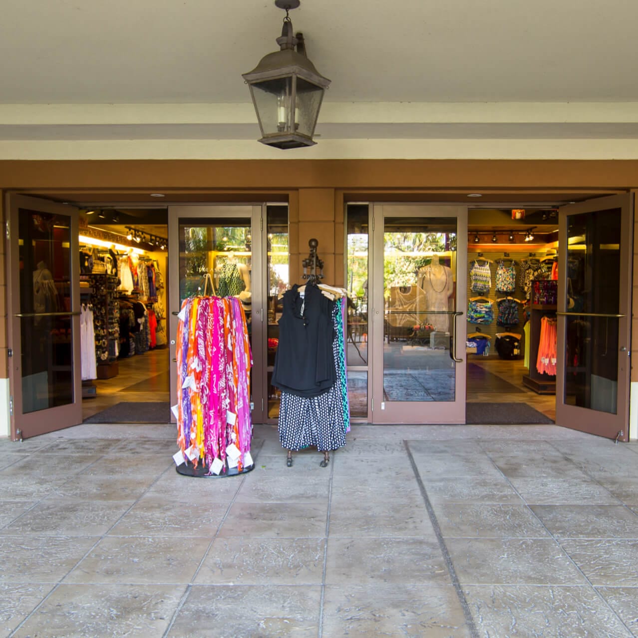 Colorful clothing displayed on racks outside the entrance to Treasures of Bali at Loews Royal Pacific Resort.