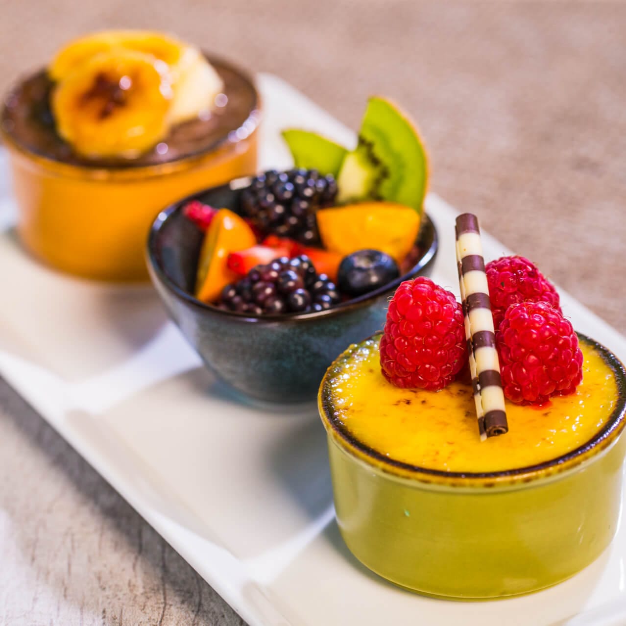 A plate with three fruit desserts at Amatista Cookhouse inside Loews Sapphire Falls Resort at Universal Orlando.
