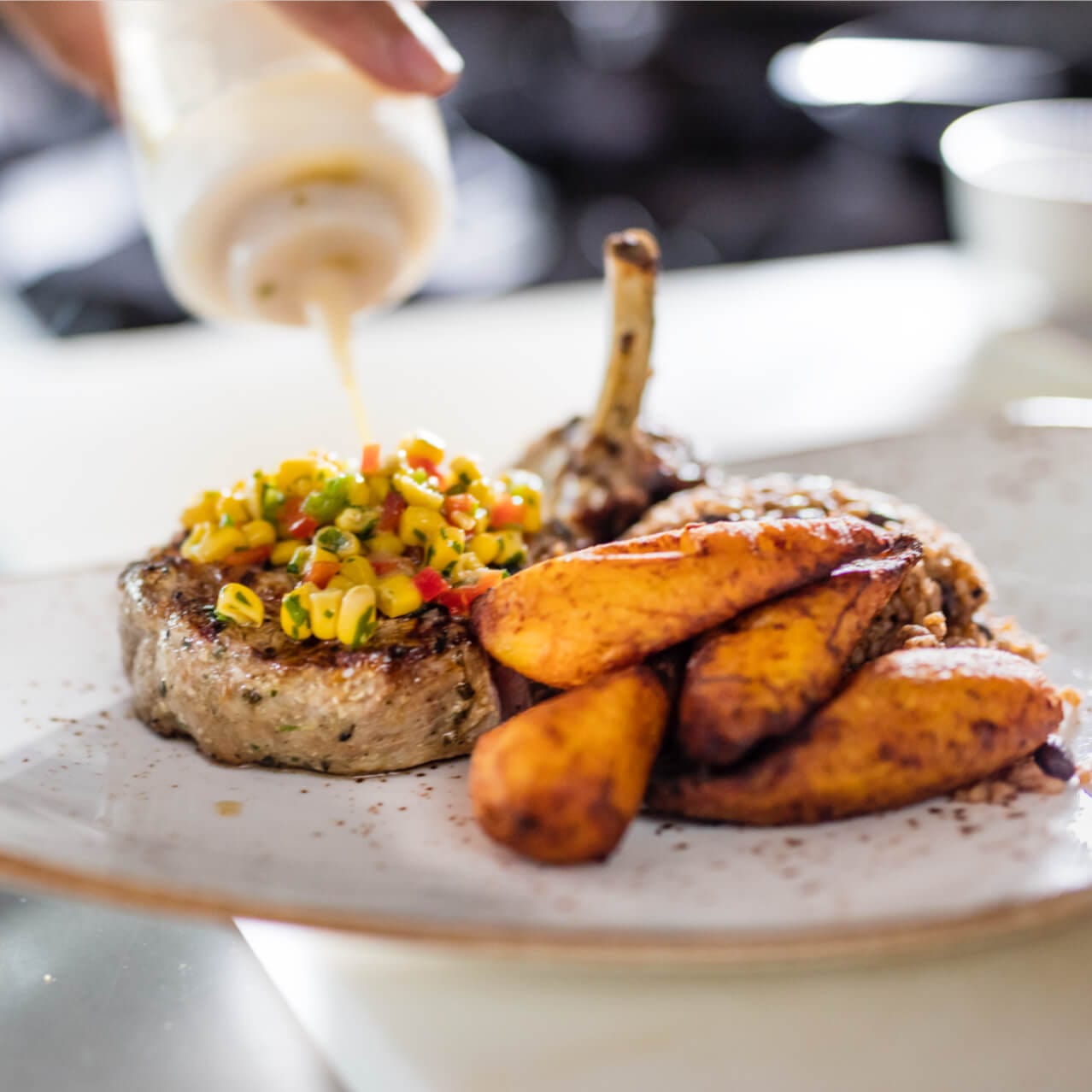 An elegantly prepared pork chop dish on display at Amatista Cookhouse, the main restaurant at Loews Sapphire Falls Resort at Universal Orlando.