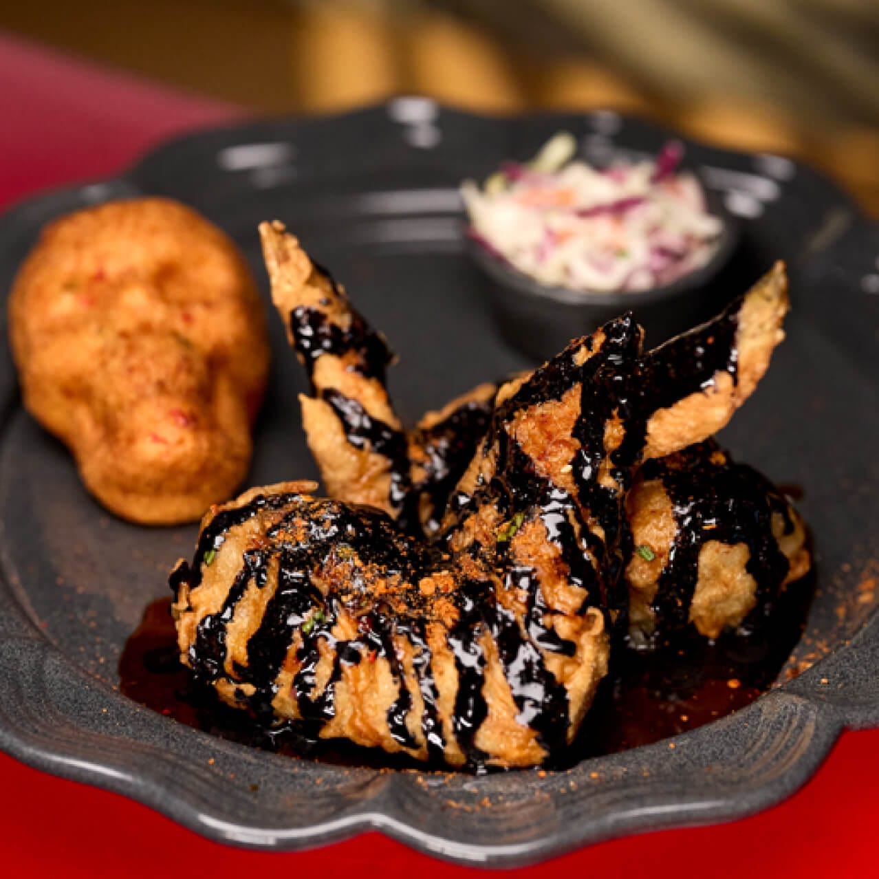 Darkmoor Black Wings are chili-dusted fried wings with smoky cheddar, charred scallions and soy chili garlic sauce, available at Das Stakehaus in Dark Universe.
