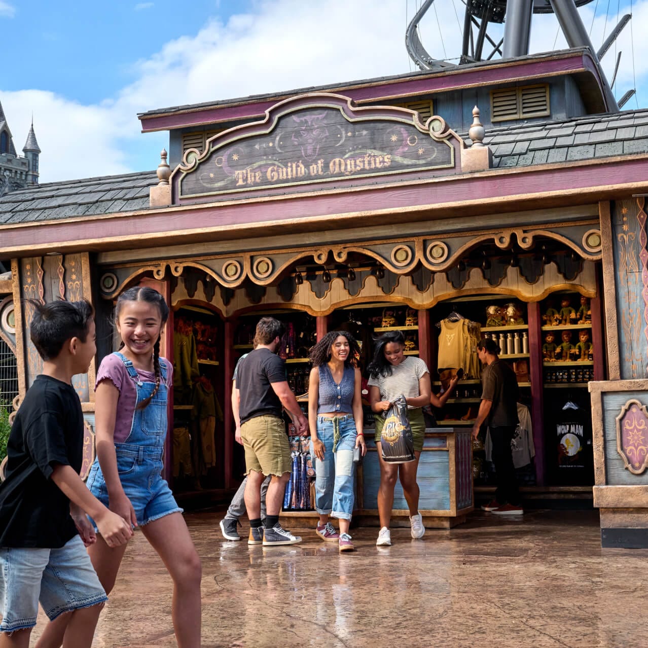 Guests walk past The Guild of Mystics shop in Dark Universe.