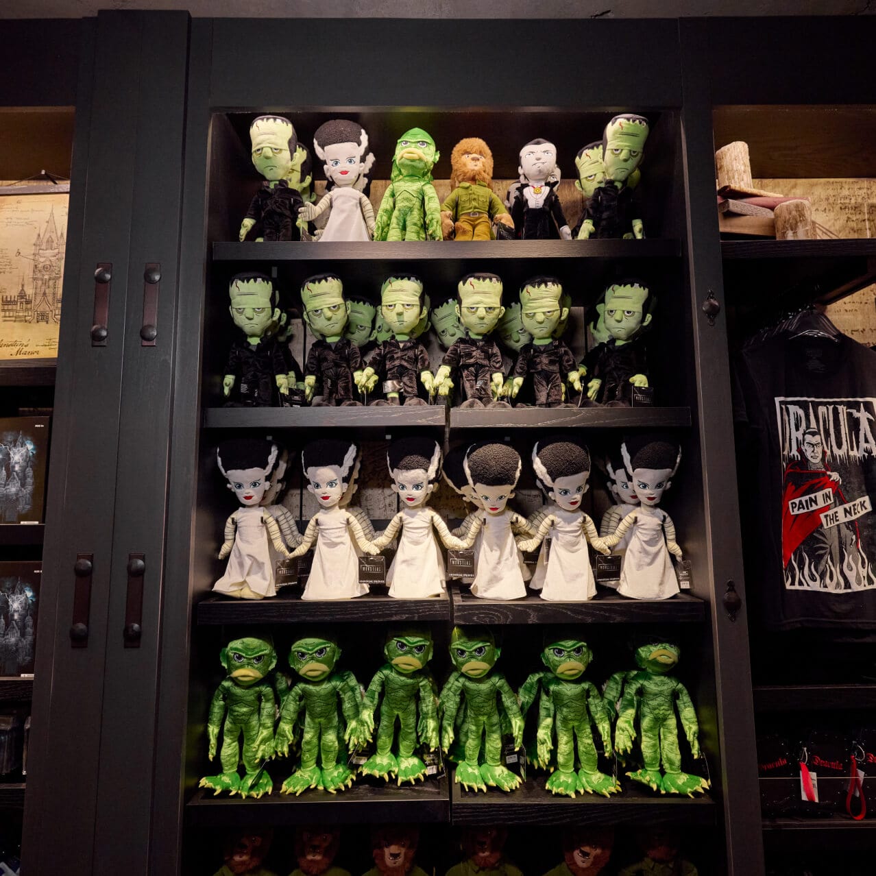 Display of plush Frankenstein's Monsters, Bride of Frankensteins, and Creatures from the Black Lagoon, among other monster-themed merchandise at Manor Storehouse.