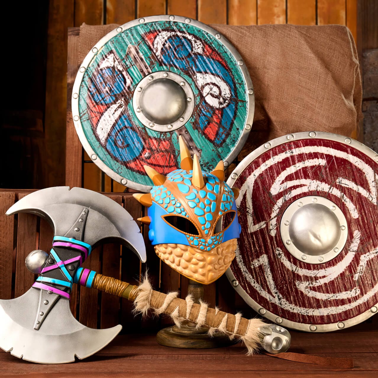 Colorful toy battle axes, helmets and shields, sold in How to Train Your Dragon - Isle of Berk at Universal Epic Universe.