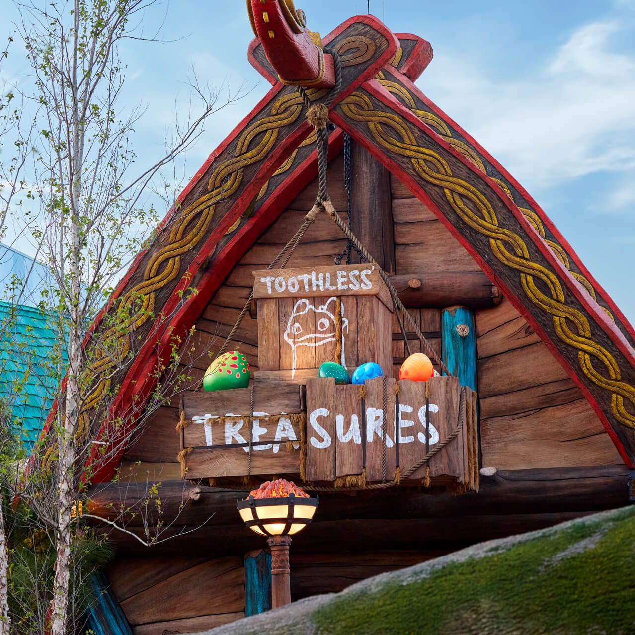 The colorful exterior facade of Toothless' Treasures, complete with dragon eggs, Viking architecture and a store front sign, in How to Train Your Dragon – Isle of Berk