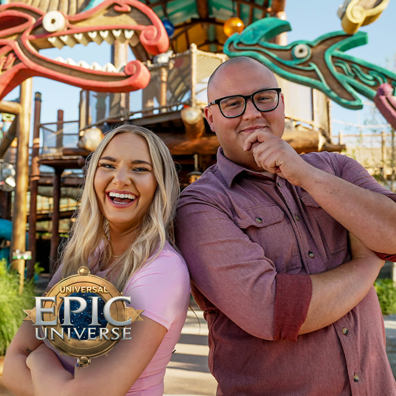 Two smiling Guest standing back-to-back by a dragon-themed playground with a Universal Epic Universe logo and a play button.